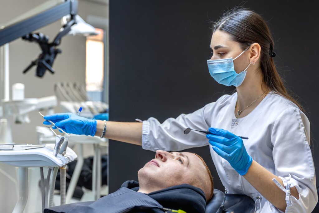 Dentist examining patient in modern clinic setting, Tijuana