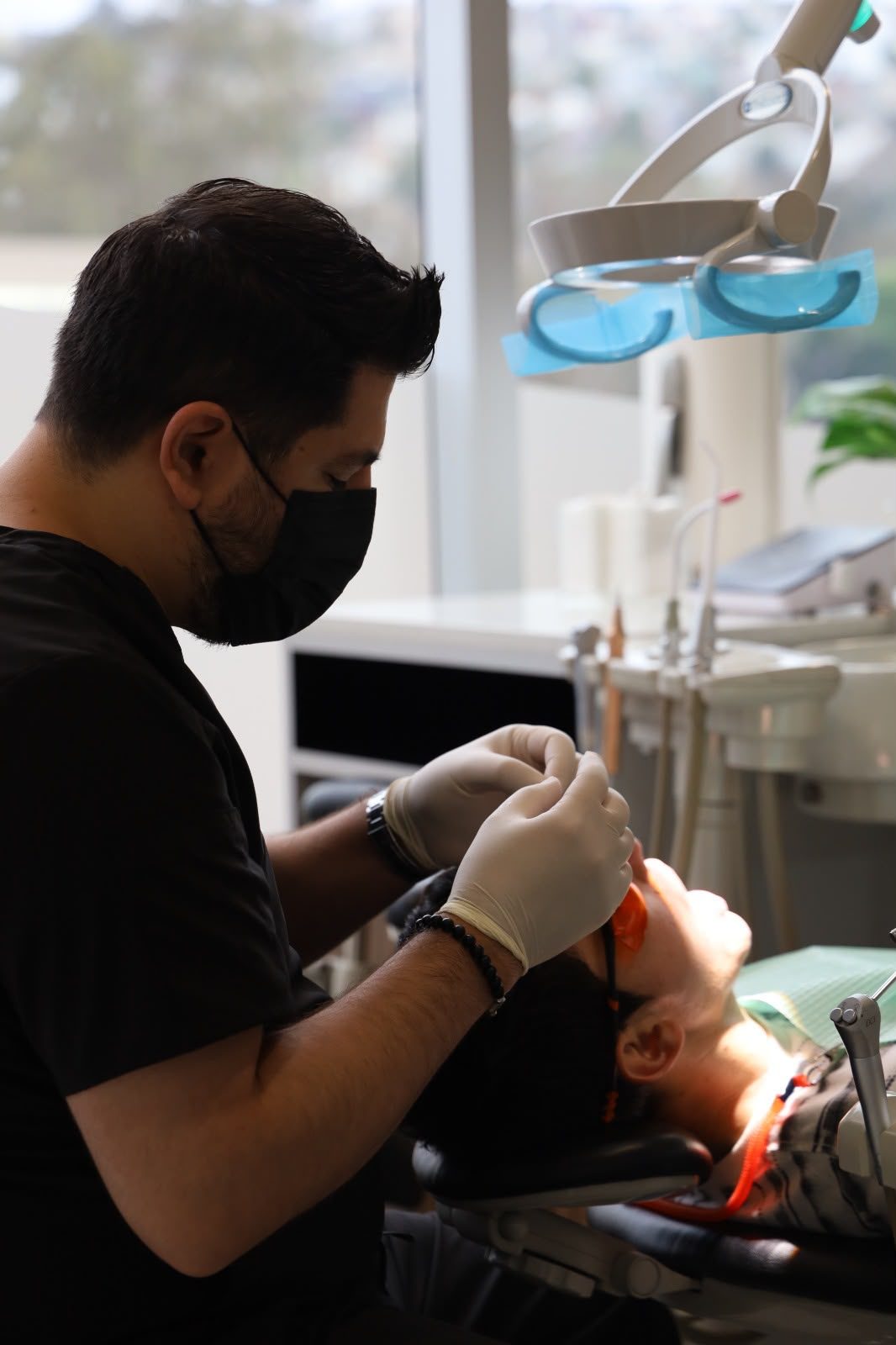 Dentist treating a patient in the operatory at Makeover Dental Studio in Tijuana