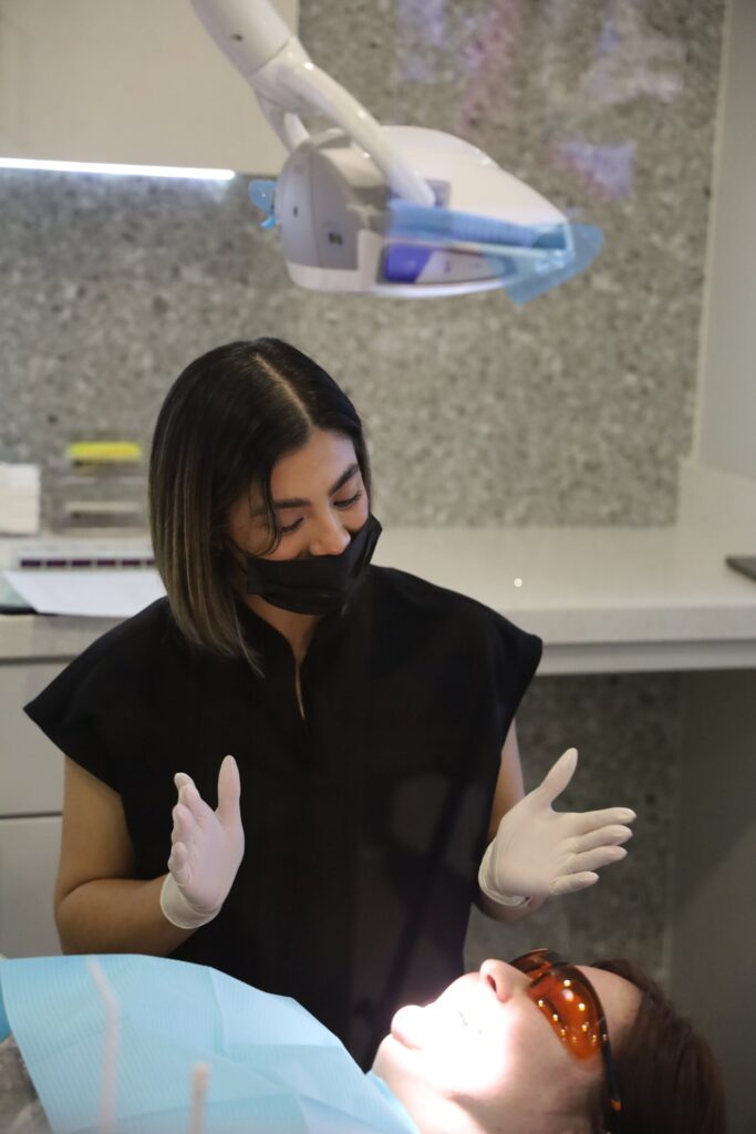 Assistant beside a patient during treatment