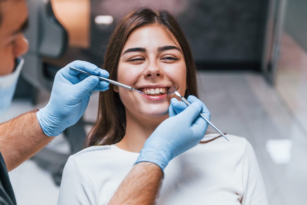 Young woman smiling during a dental exam