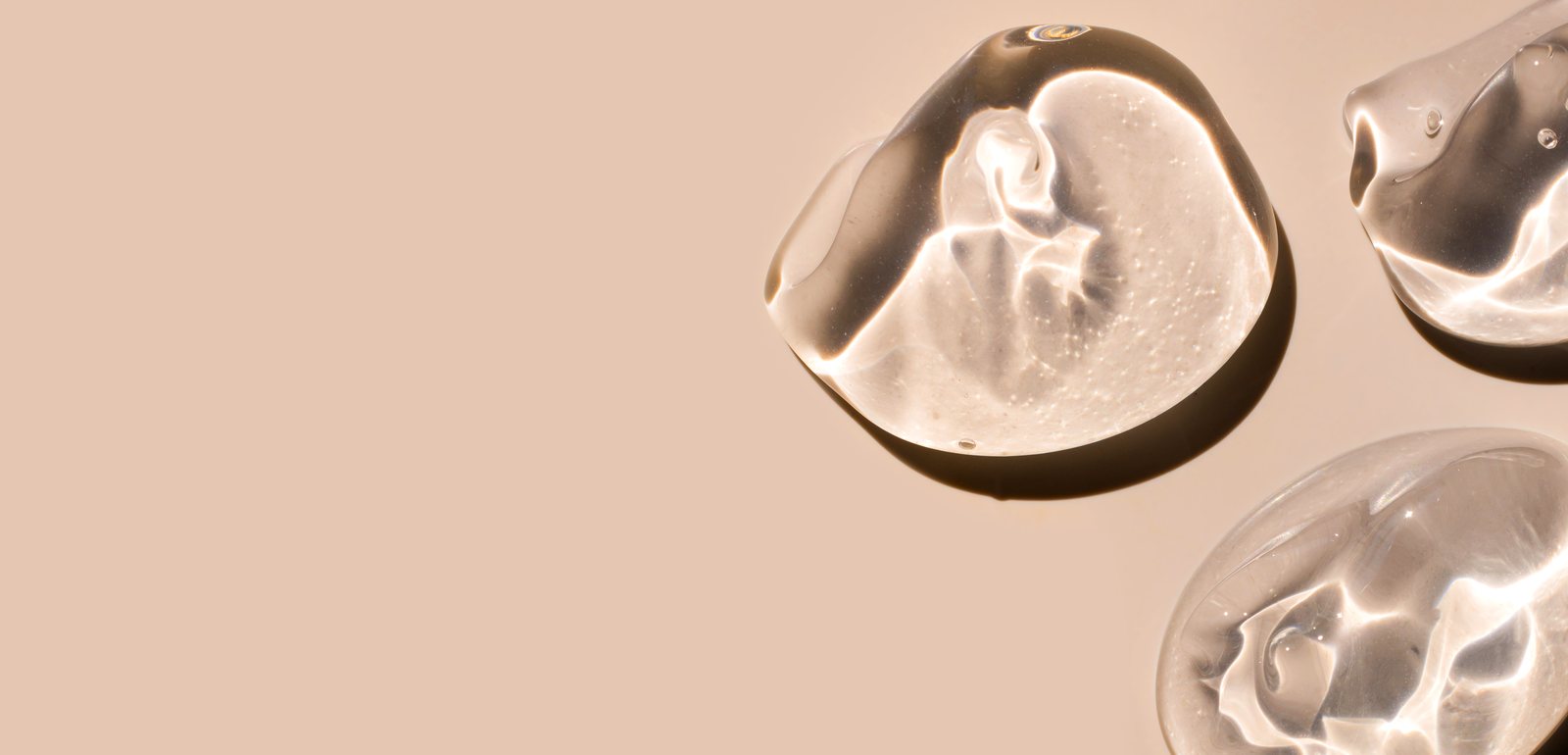 Transparent gel droplets on light brown background, Tijuana