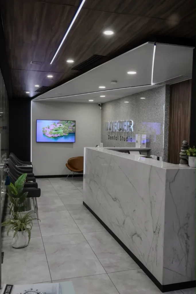 Makeover Dental Studio reception with illuminated logo and waiting lounge in Tijuana