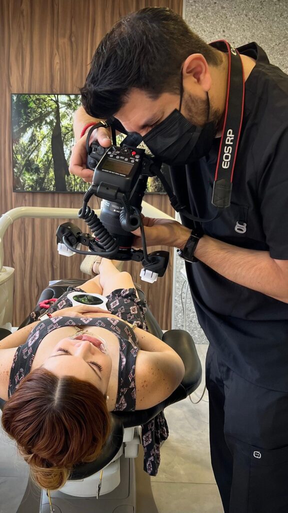 Dentist taking clinical photographs of a patient at Makeover Dental Studio